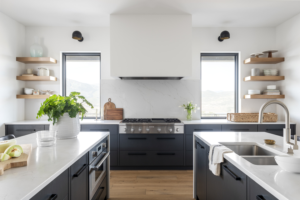 Open concept kitchen with dark blue cabinets and white countertops