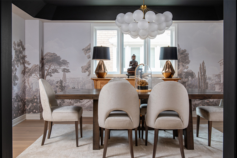 wood flooring with area rug in dining room Design by Aman Than Interiors and Photography by Mike Chajecki